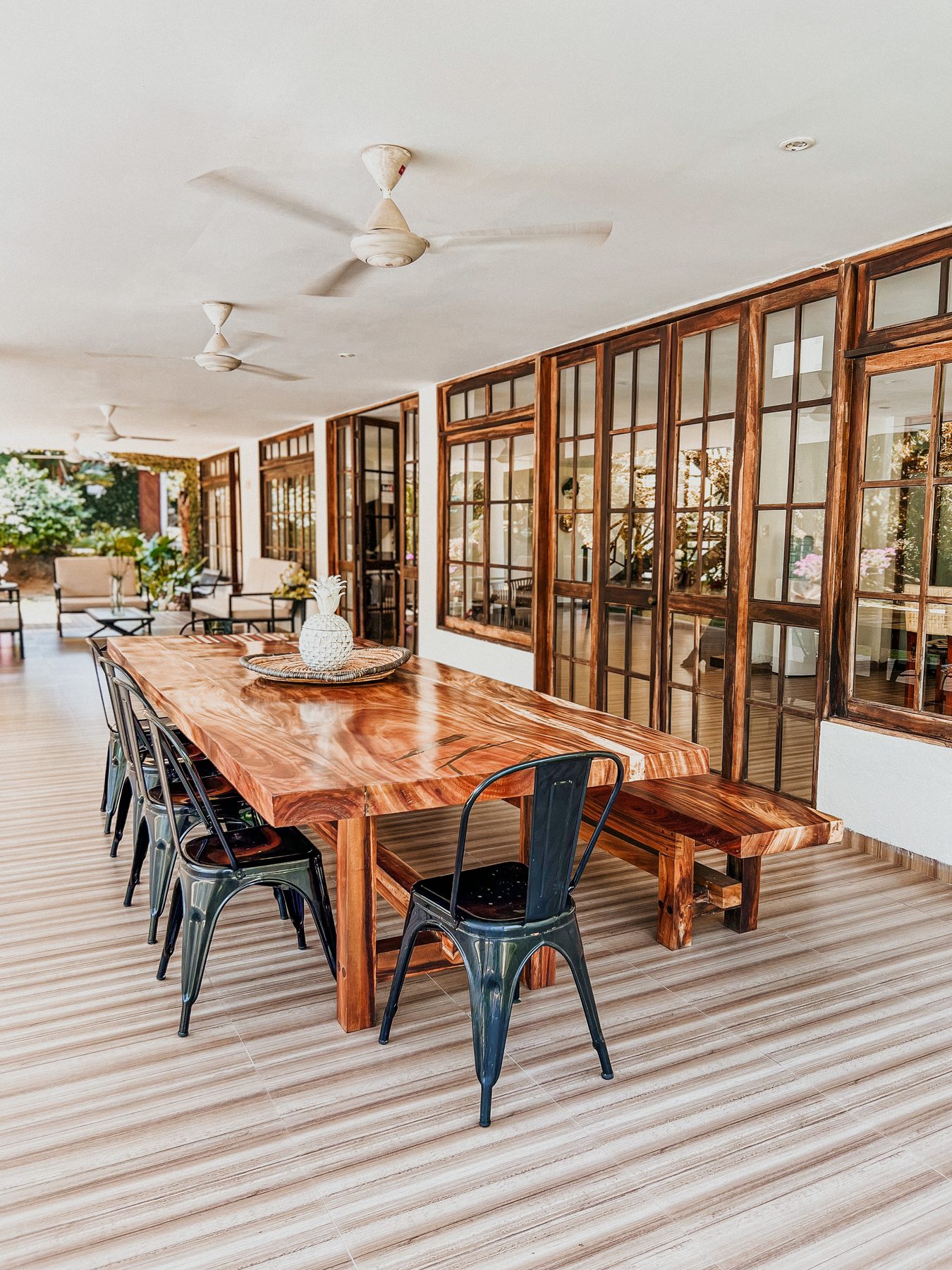 Long solid-wood dining table on the veranda