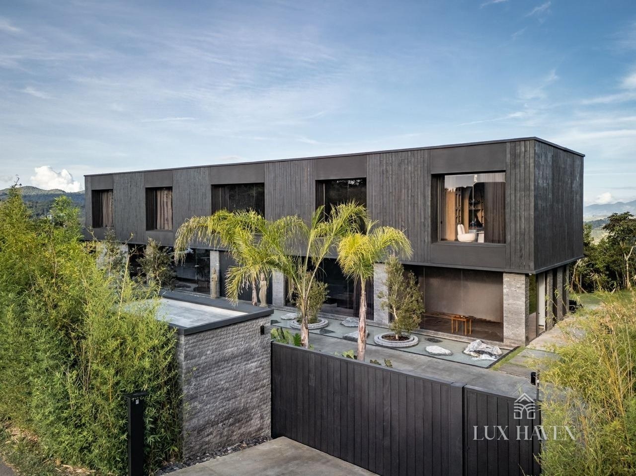 Fassade aus verkohltem Holz mit tropischen Gärten